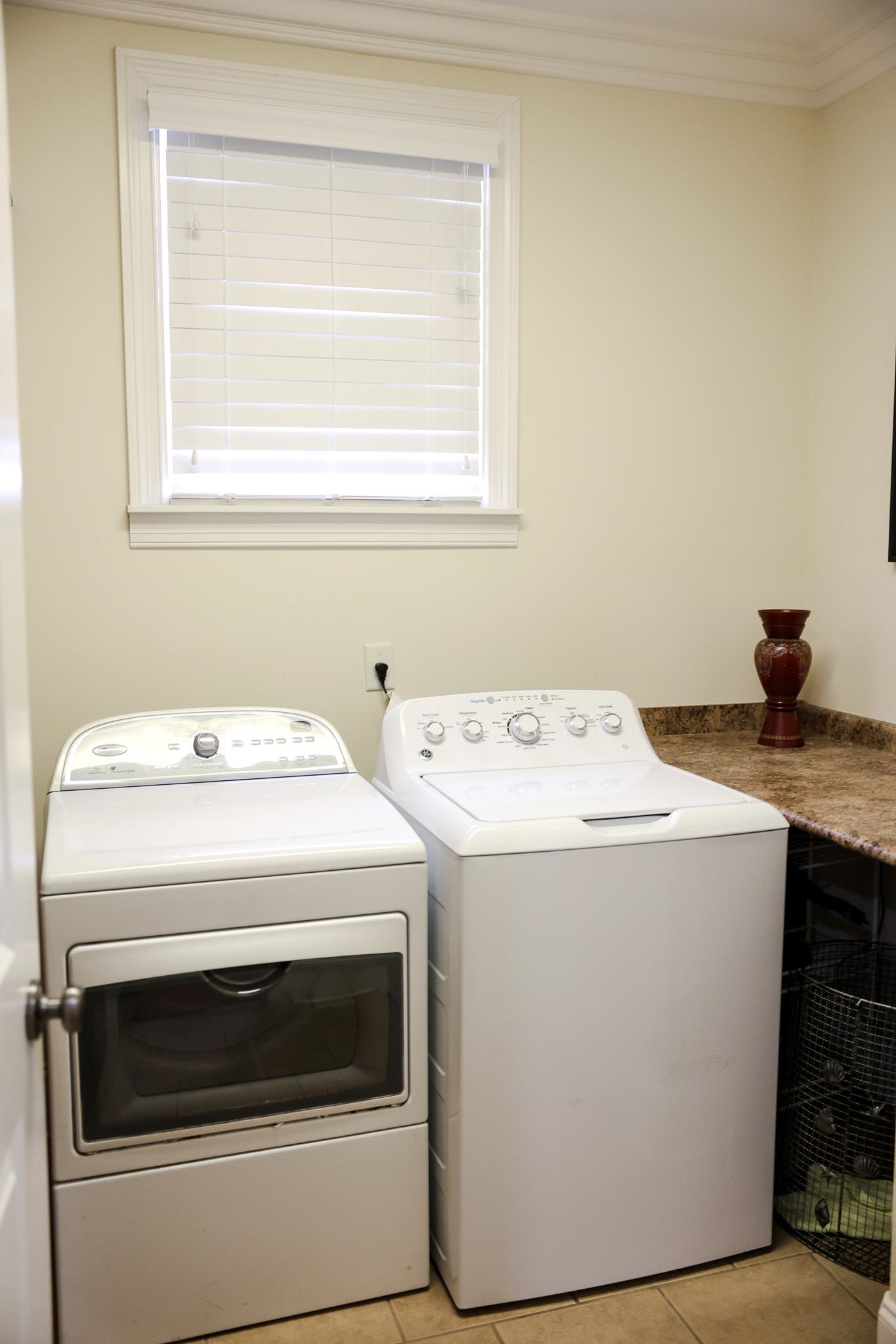 649 Ridge Springs Road Collierville, TN 38017 - Photo 25 of 35 Washroom with light tile patterned floors, independent washer and dryer, and crown molding