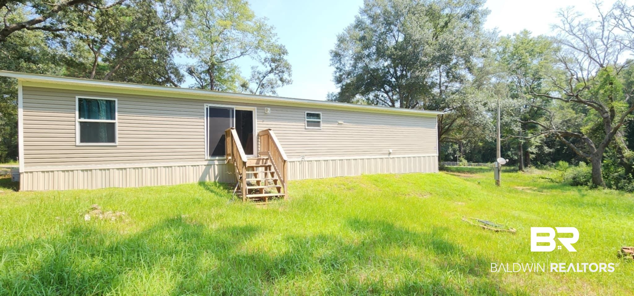 25474 Waterworld Road Robertsdale, AL 36567 - Photo 28 of 30 Rear view of house featuring a lawn
