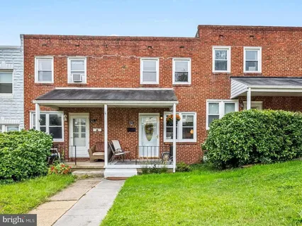 front view of a brick house with a yard