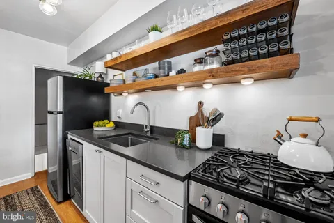 a view of a patio with couches table and chairs and potted plants