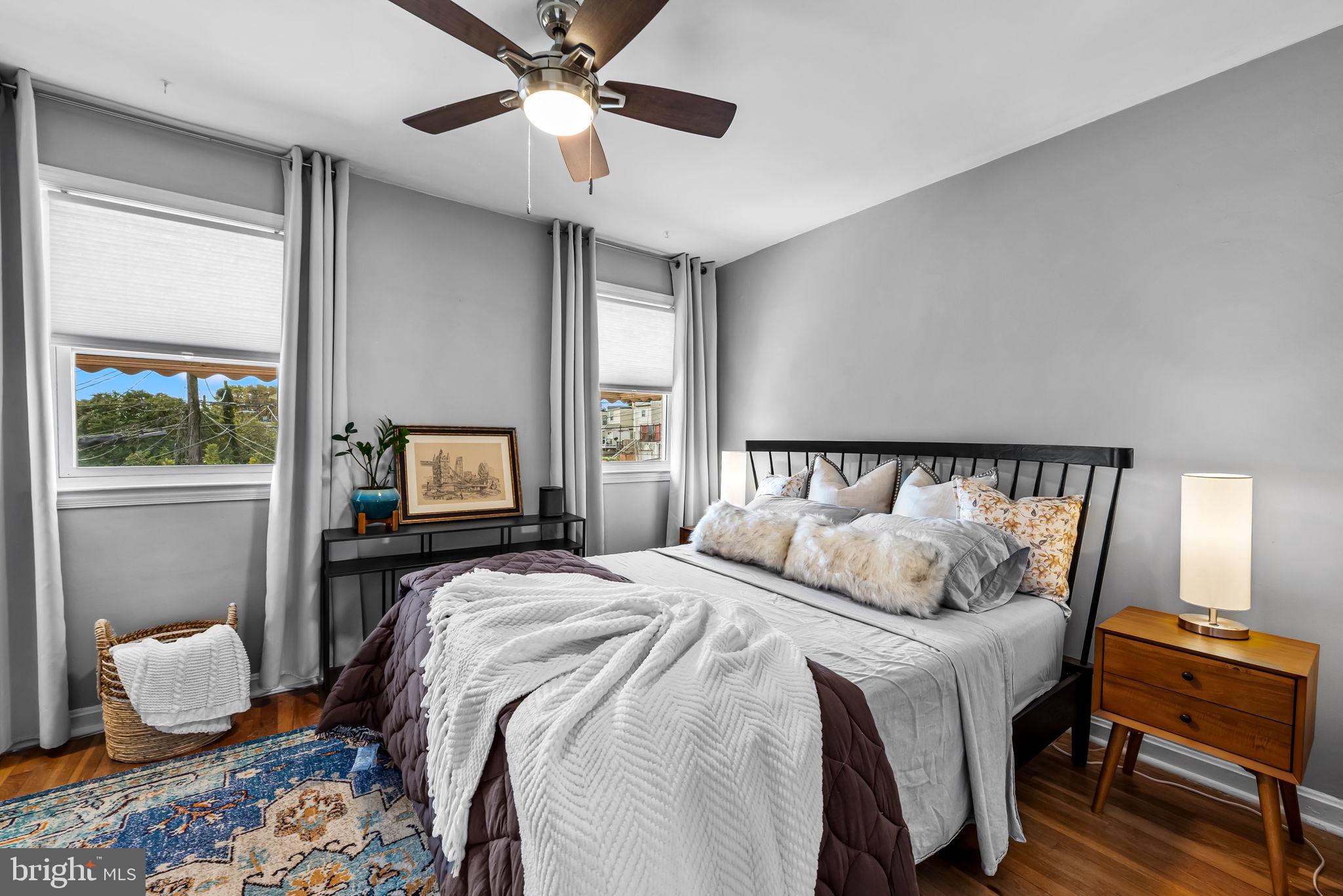 615 West 36th Street Baltimore, MD 21211 - Photo 16 of 29 a bedroom with a bed and wooden floor