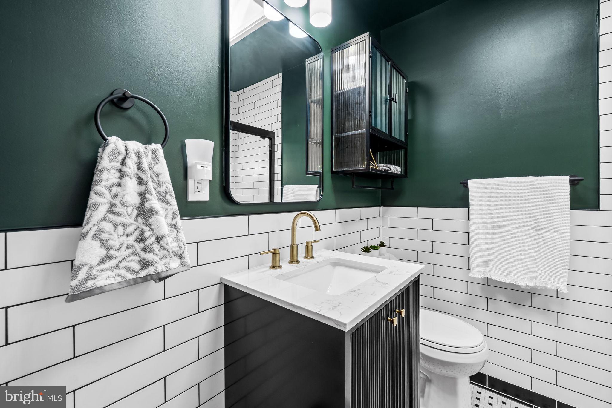 615 West 36th Street Baltimore, MD 21211 - Photo 19 of 29 a bathroom with a sink and a toilet