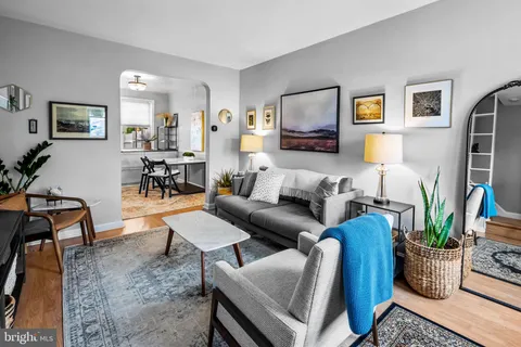 a living room with furniture potted plant and a table