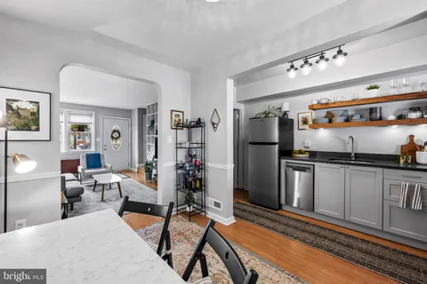 a kitchen with stainless steel appliances granite countertop a refrigerator and a stove