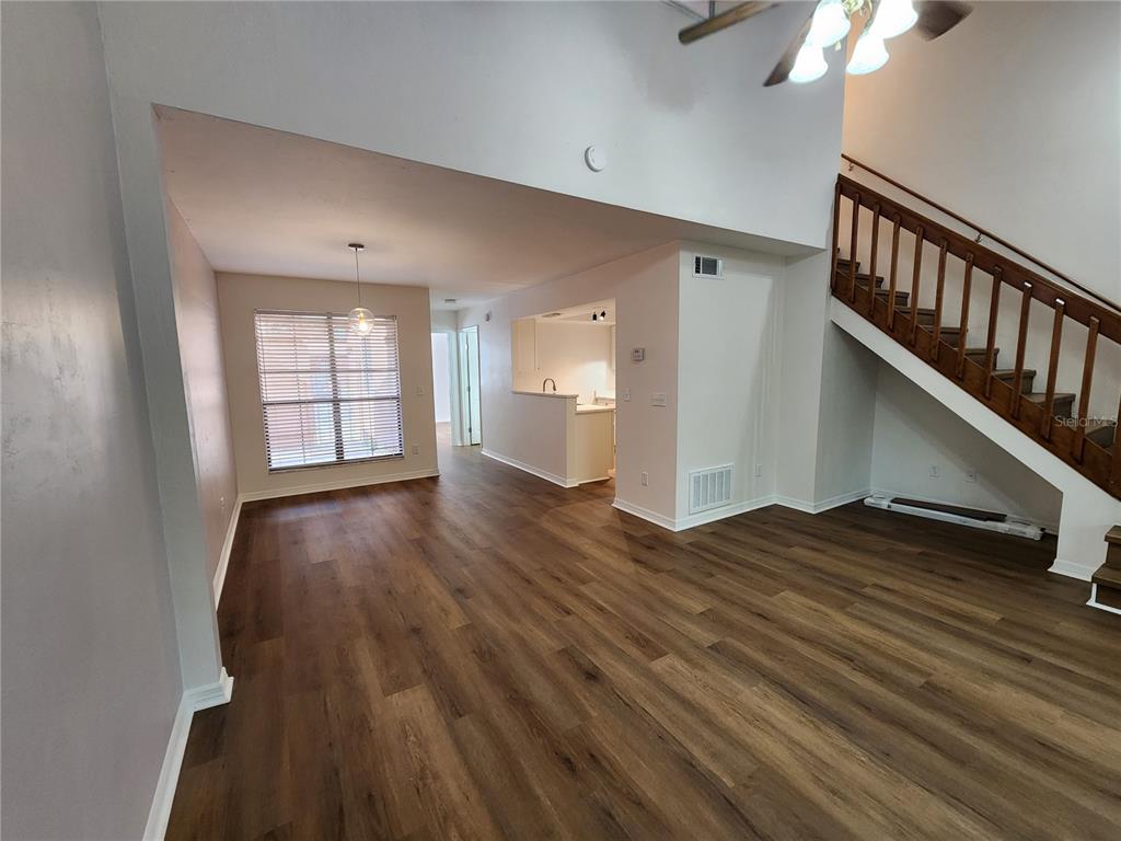 5823 Southwest 9th Place, Unit H55 Gainesville, FL 32607 - Photo 5 of 50 wooden floor in an empty room with a window