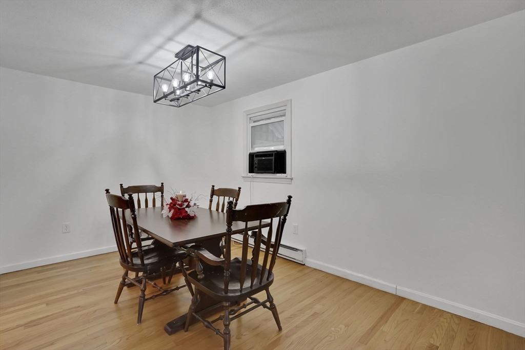 290 Newton Road Springfield, MA 01118 - Photo 11 of 38 a view of a dining room with furniture a chandelier and wooden floor