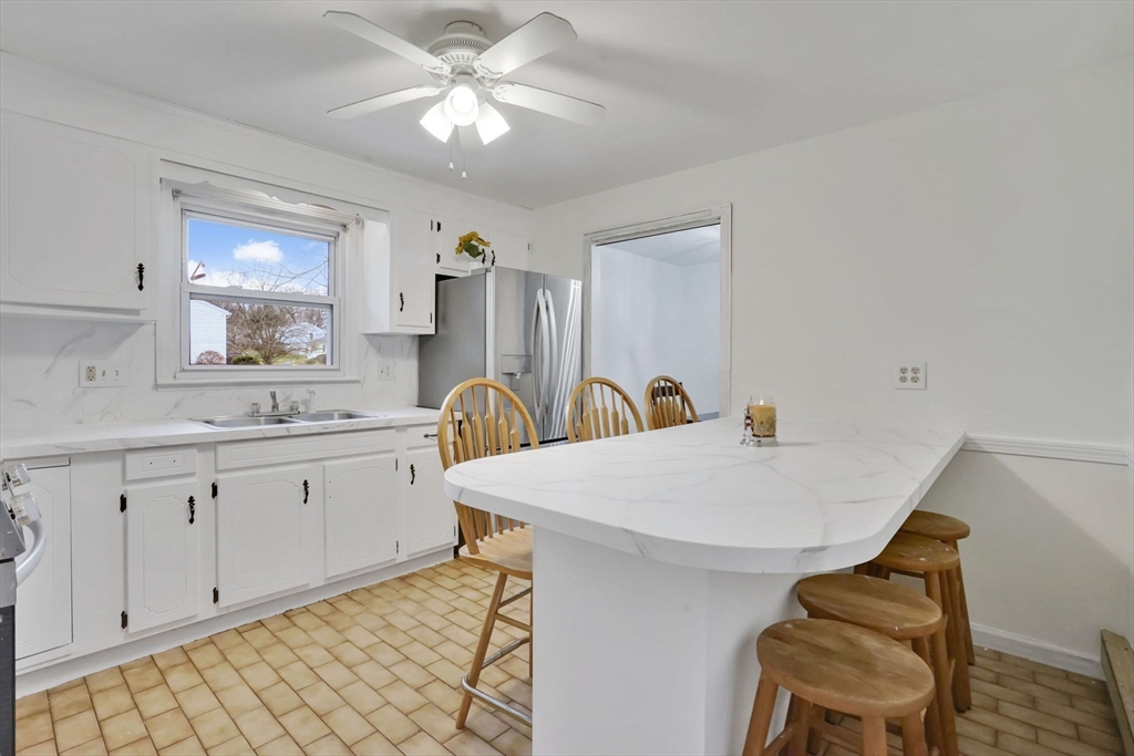 290 Newton Road Springfield, MA 01118 - Photo 13 of 38 a view of a kitchen area with furniture and chandelier