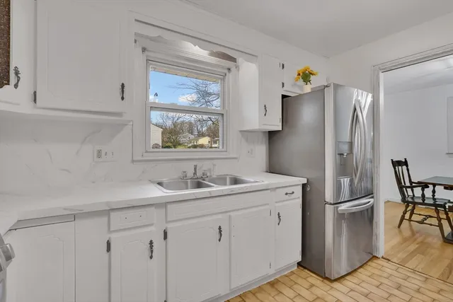 a kitchen with stainless steel appliances a refrigerator sink and cabinets