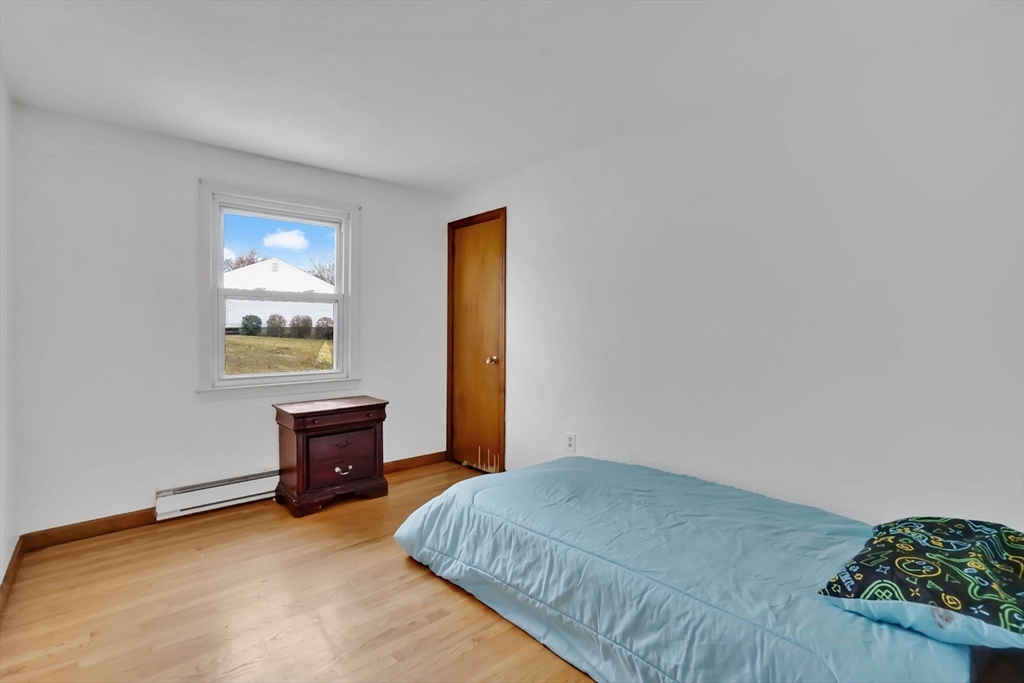 290 Newton Road Springfield, MA 01118 - Photo 18 of 38 a bedroom with a bed and a table in it