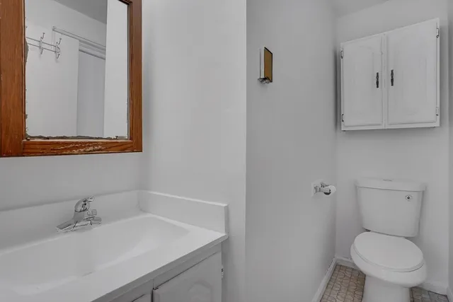 a bathroom with a sink toilet and vanity