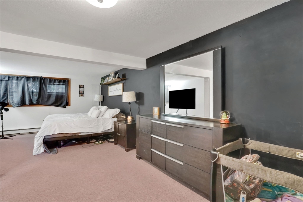 290 Newton Road Springfield, MA 01118 - Photo 26 of 38 a bedroom with a bed and a flat screen tv