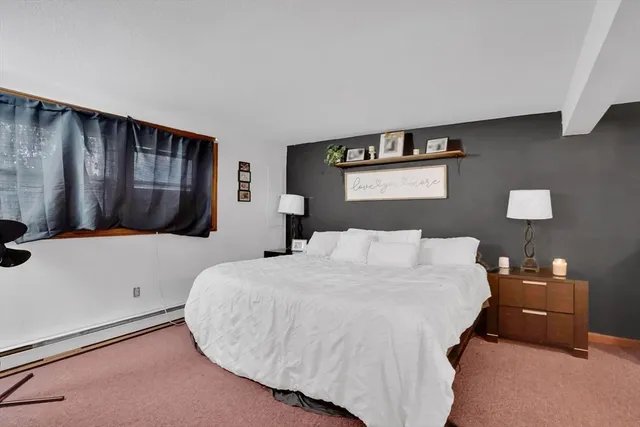 a bed room with a bed and a night stand