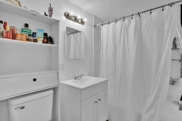 a bathroom with a shower and a sink