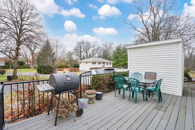 a view of a deck with table and chairs and wooden floor