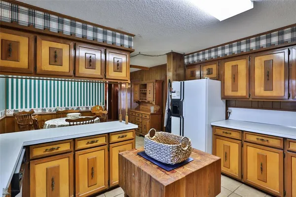 a kitchen with a table chairs sink and cabinets