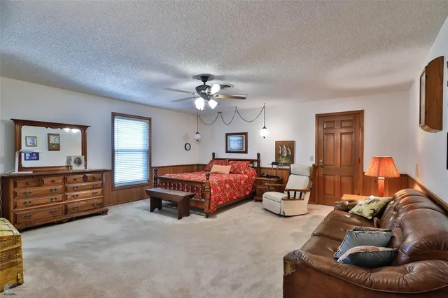 a en suite bathroom with a granite countertop sink a mirror and a