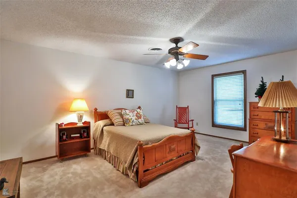 a view of swimming pool with outdoor seating and trees