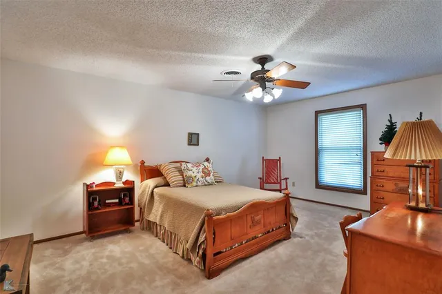 a view of swimming pool with outdoor seating and trees