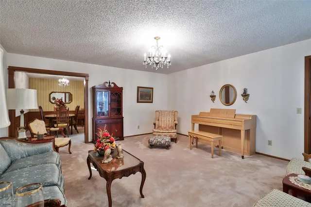 a dining room with furniture a chandelier and window