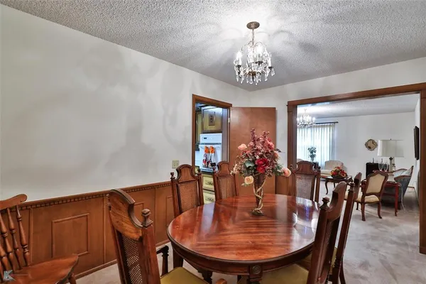 a kitchen that has a table and chairs in it