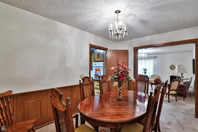 a kitchen that has a table and chairs in it