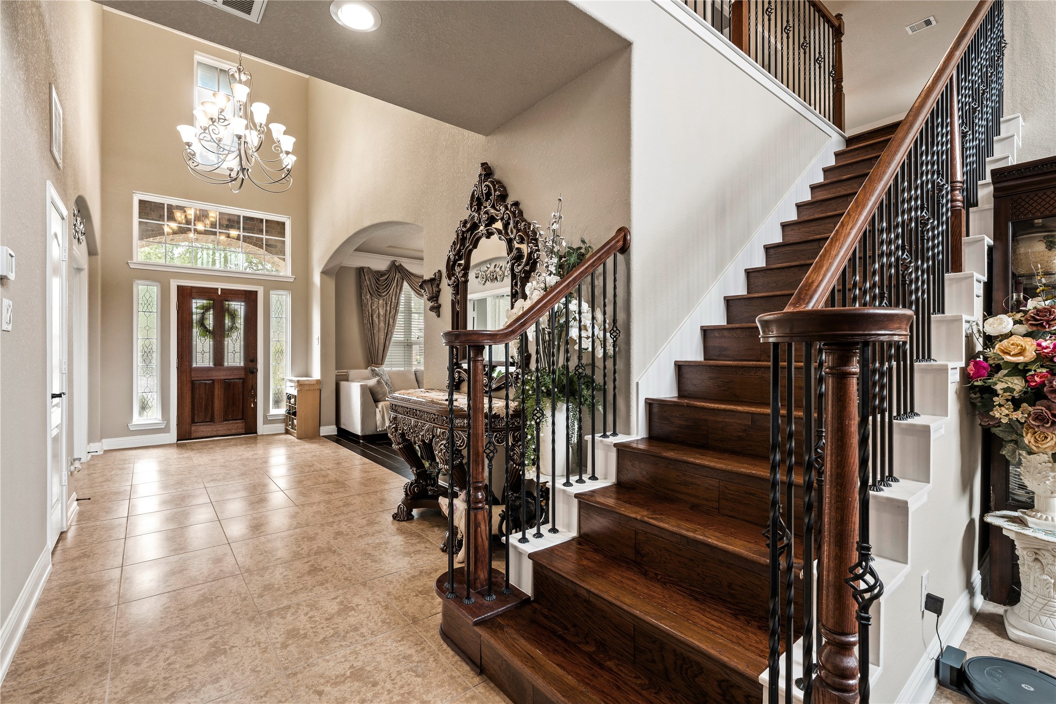 5802 Layton Meadows Lane Spring, TX 77379 - Photo 28 of 42 Grand two-story foyer. Chandelier, soaring ceilings, hardwood and wrought-iron staircase, stained glass front door, arched doorways