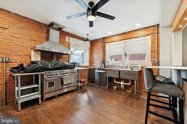 a kitchen with stainless steel appliances granite countertop a stove and a dining table