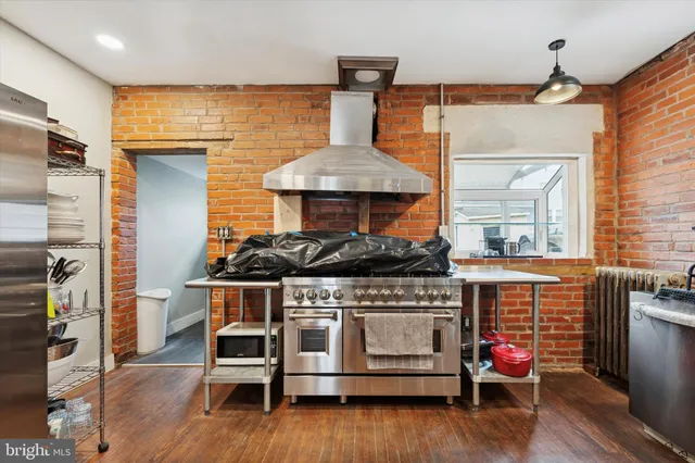 a kitchen with stainless steel appliances granite countertop a stove and a refrigerator