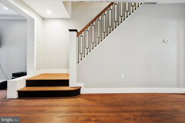 a view of entryway and hall with wooden floor