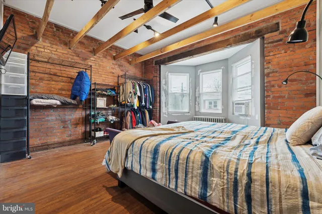 a bed sitting in a bedroom next to a window