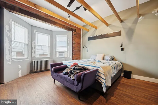 a bedroom with a bed and a large window