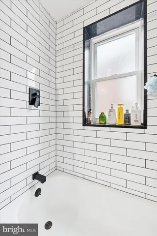 a bathroom with a bathtub and a window