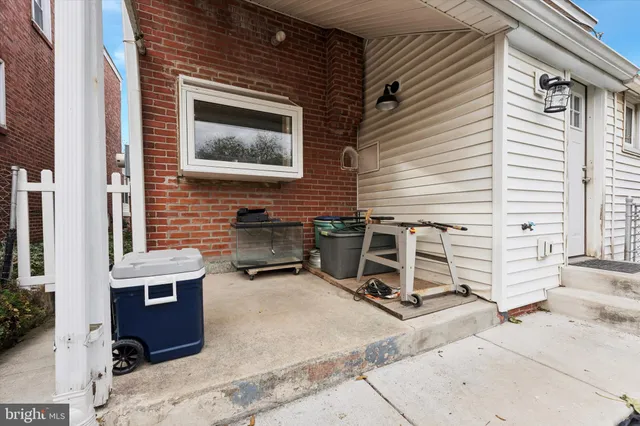 a backyard of a house with barbeque oven table and chairs