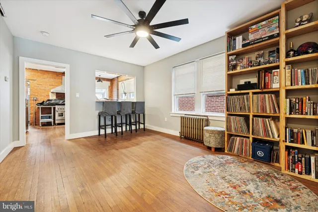 a view of a livingroom with furniture and bookshelf