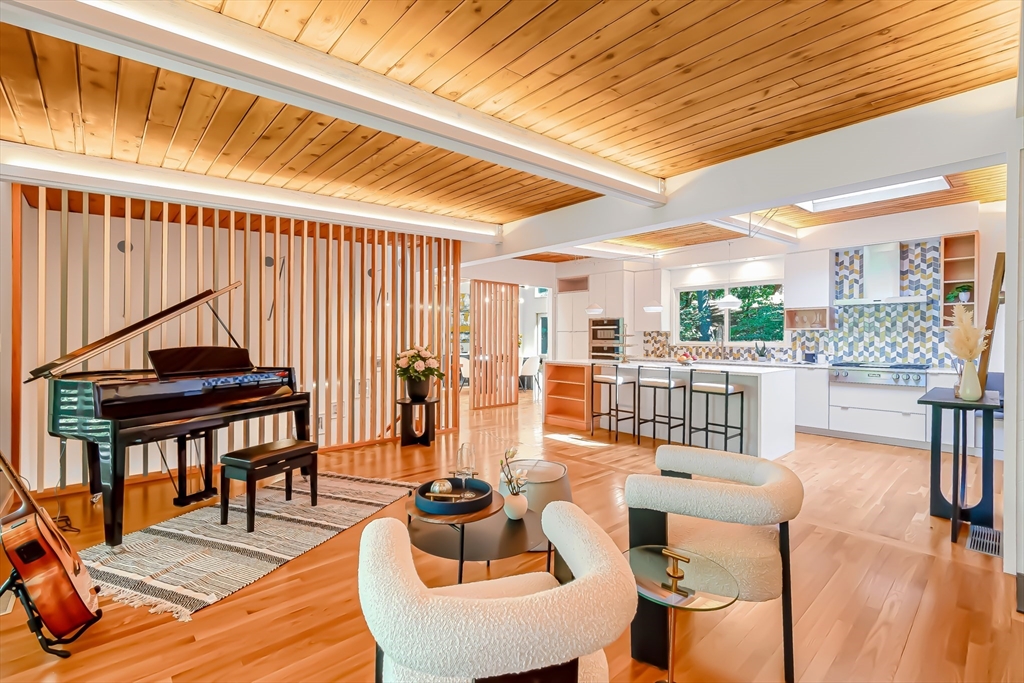 53 Beaver Road Weston, MA 02493 - Photo 12 of 42 a living room with furniture a wooden floor and a large window