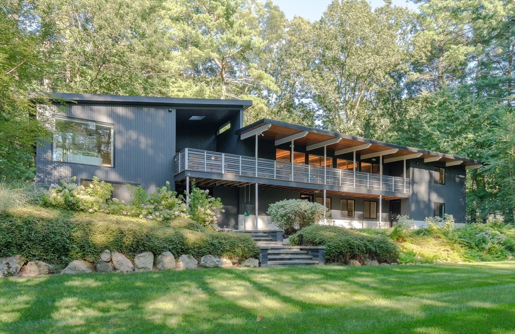 53 Beaver Road Weston, MA 02493 - Photo 2 of 42 a front view of a house with a yard and potted plants