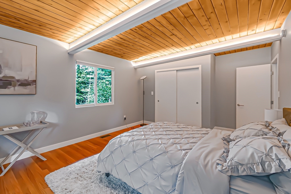 53 Beaver Road Weston, MA 02493 - Photo 24 of 42 a bed sitting in a bedroom next to a window