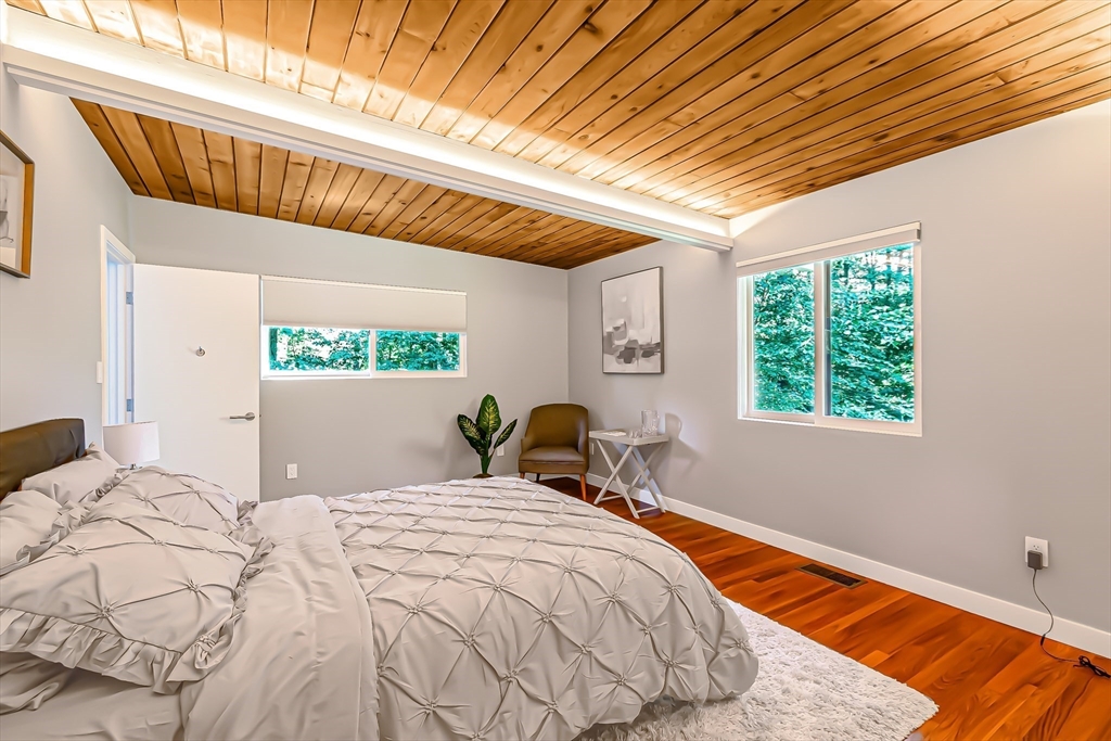 53 Beaver Road Weston, MA 02493 - Photo 25 of 42 a bed sitting in a bedroom next to a window