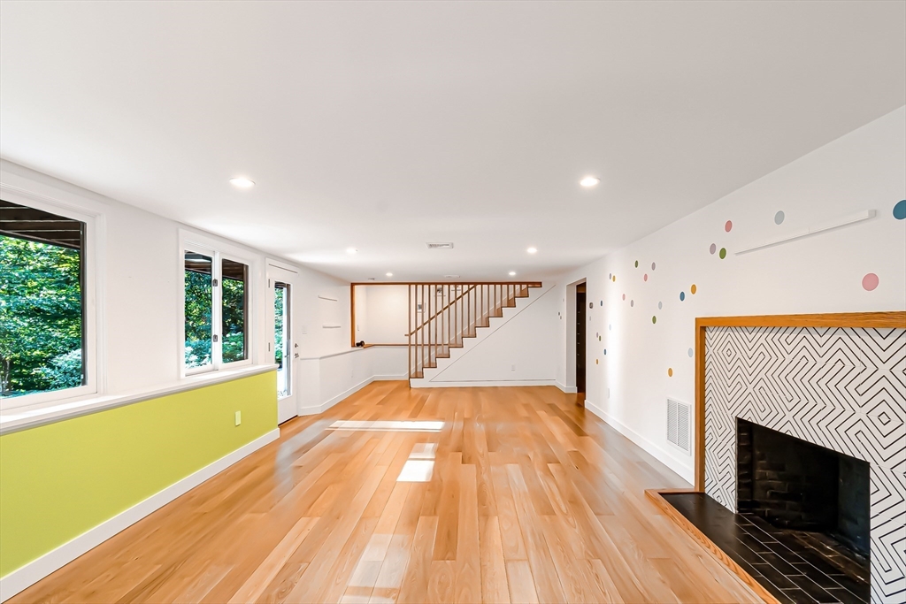 53 Beaver Road Weston, MA 02493 - Photo 27 of 42 a spacious bedroom with a large bed and a fireplace