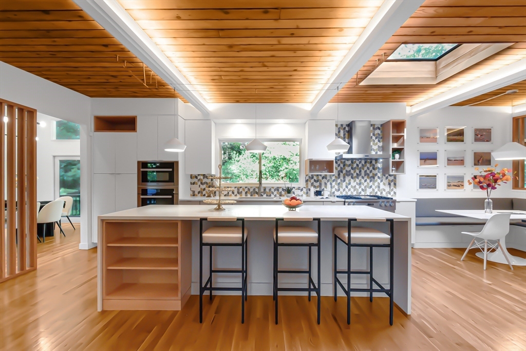 53 Beaver Road Weston, MA 02493 - Photo 3 of 42 a room with stainless steel appliances granite countertop a table chairs and a wooden floor