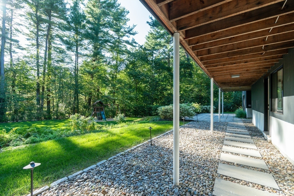 53 Beaver Road Weston, MA 02493 - Photo 35 of 42 a view of a backyard with couches plants and large trees