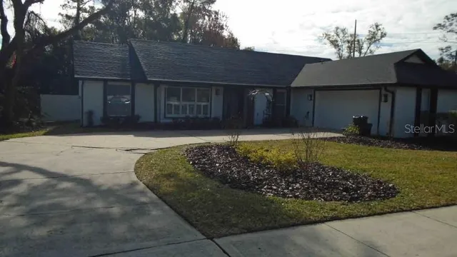 a house with lots of trees in the background