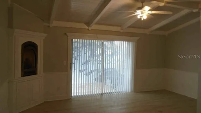 a view of a livingroom with a chandelier fan