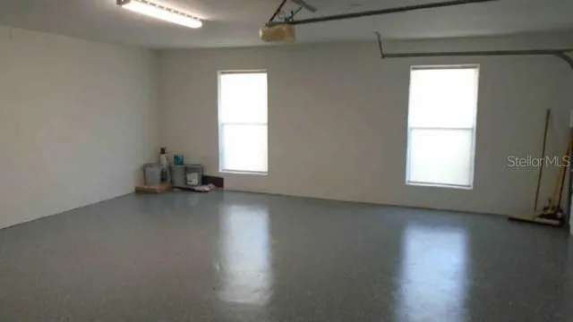 a view of a room with wooden floor and windows