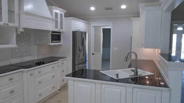 a bathroom with a granite countertop sink a mirror and shower