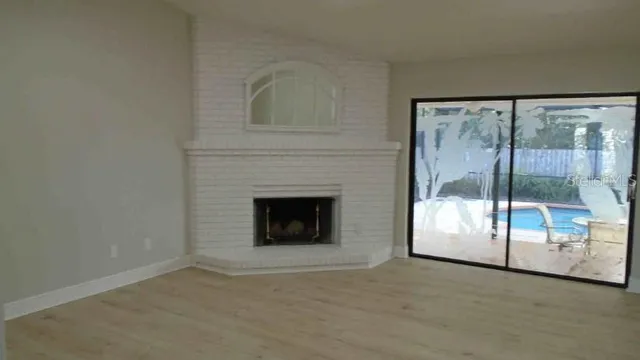 a view of an empty room with a fireplace