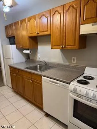 a kitchen with granite countertop cabinets stainless steel appliances and a sink