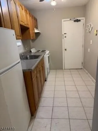 a kitchen with a sink a stove top oven and cabinets