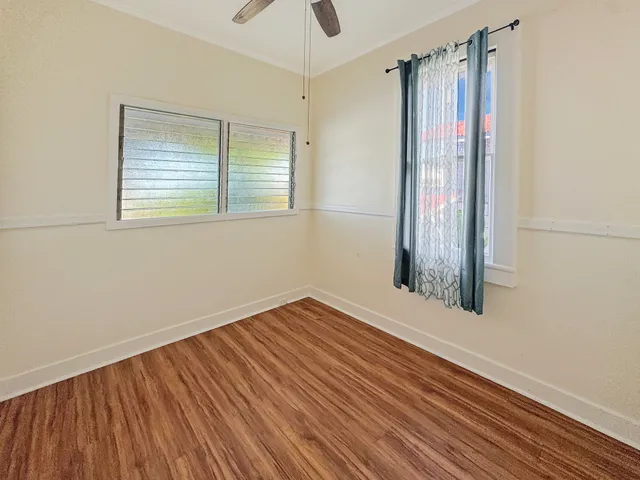 a view of a room with wooden floor and a window