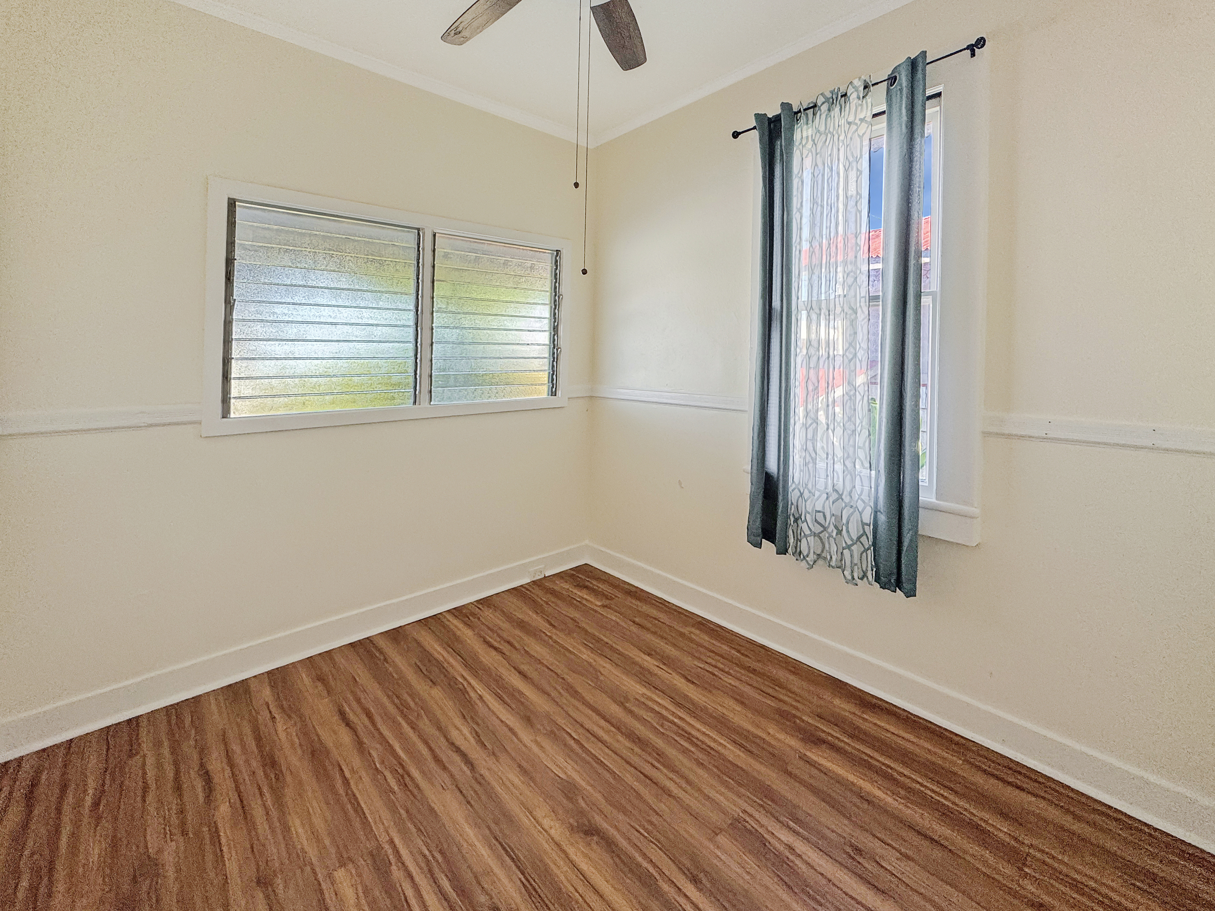 136 Mauna Loa Street Hilo, HI 96720 - Photo 12 of 23 a view of a room with wooden floor and a window